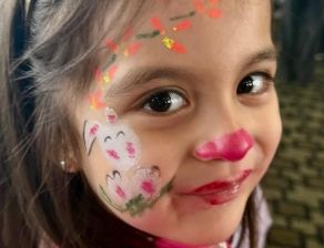 Smiling girl with face paint at Bee Smart Preschool Education enjoying an art and creativity activity that promotes self-expression and joy.